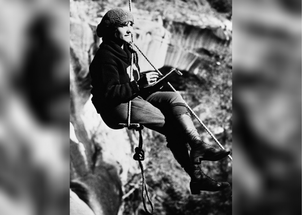 Mountaineer sketching on rope swing